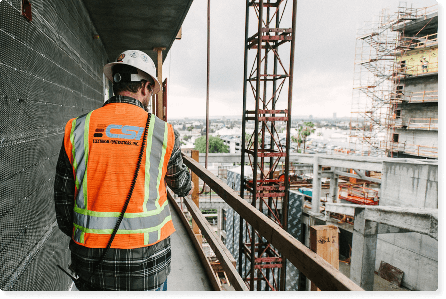 Construction worker from CSI walking on a commercial construction job site