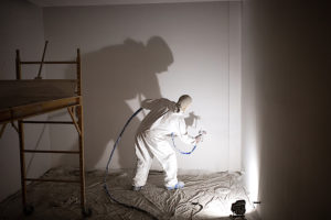 Painter spraying on a construction project - Including retainage in your payment application