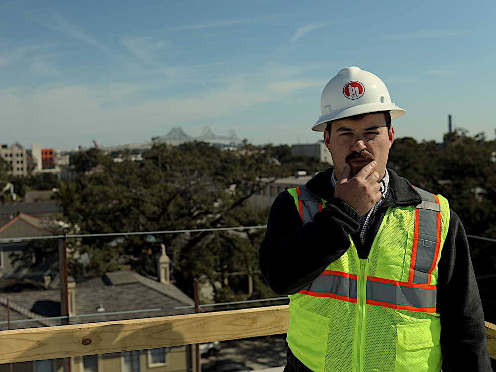 Man in hard hat and vest standing on top of a building | How to recognize payment issues on a construction project