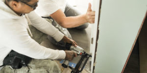 Contractors repairing a door frame | California Service and Repair Contract