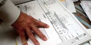 Contractor reviews schedule and budget for construction project