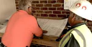 Construction consultant reviewing blueprints