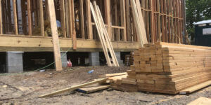 Lumber stacked outside of new residential construction project