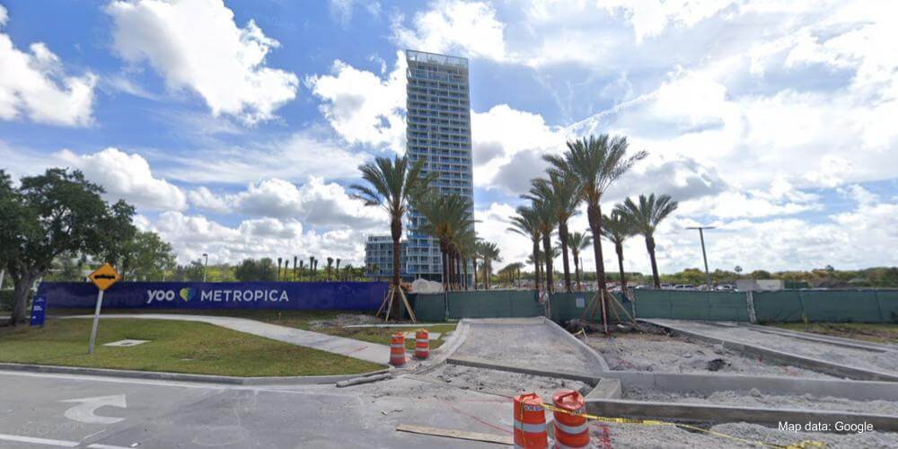 Exterior view of the Metropica project still under construction with the completed Tower One visible