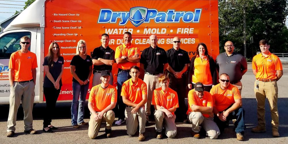 Photo of the Dry Patrol staff outside their company truck