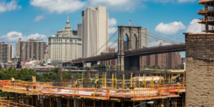 Photo of construction site with Brooklyn Bridge visible in the background