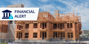 Photo of house being constructed with financial alert graphic