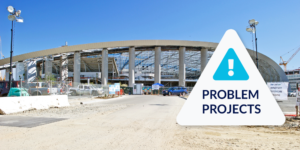 Image of SoFi Stadium under construction with problem projects icon