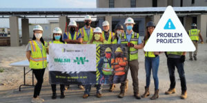 Photo of Walsh construction crew and problem project label