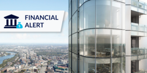 Glass exterior of building with financial alert graphic