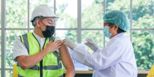 Photo of construction worker receiving a vaccine shot