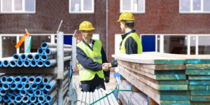 Subcontractor and contractor shaking hands on a jobsite