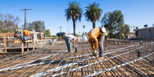 Stock photo of construction workers in California with palm trees