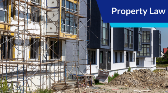 Building under construction with text overlay: Property Law