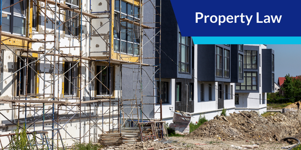 Building under construction with text overlay: Property Law