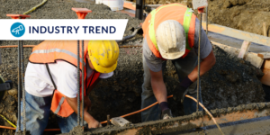 Photo of two workers working in concrete with industry trend label in the upper left corner