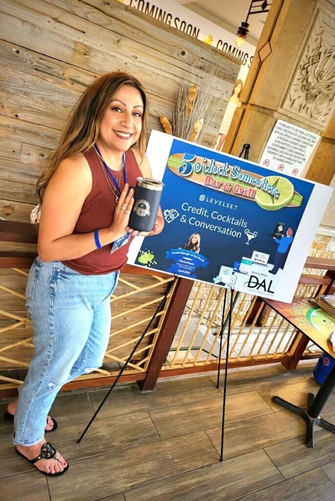 Gloria Macias with her Credit Manager of the Month Yeti & sign