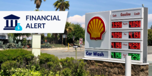 Photo of fuel price board at Shell station with Financial Alert graphic on the left side