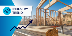 Photo of exposed lumber on an unfinished house and a pile of lumber. There is an "industry trend" label in the upper left corner, and an upward graph arrow illustration.