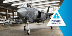 Photo of military plane in a hangar with Problem Projects label on right side