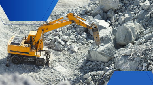 Photo of an excavator moving rocks in a quarry