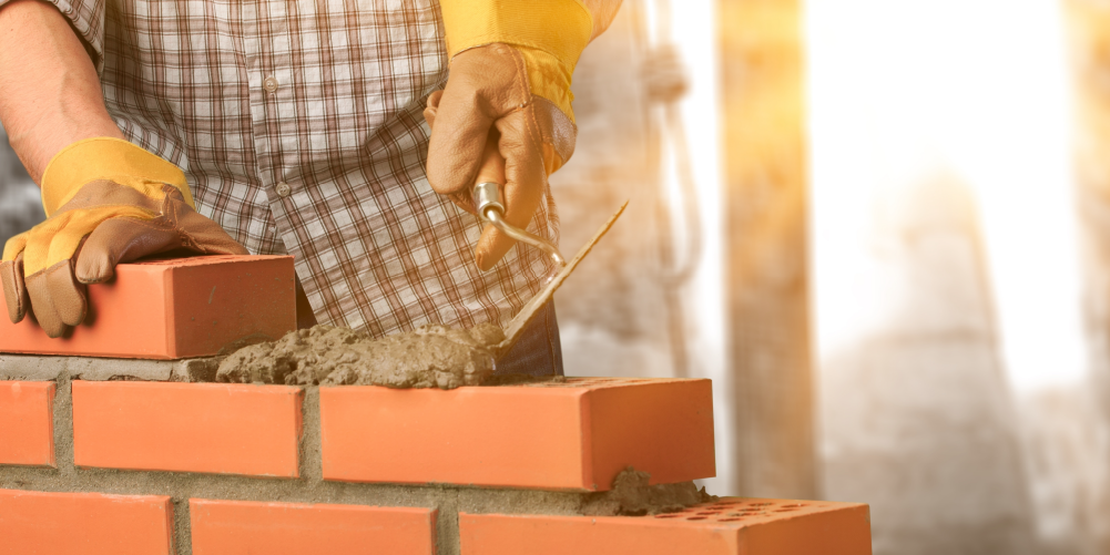 Photograph of ferrock being laid between red bricks.